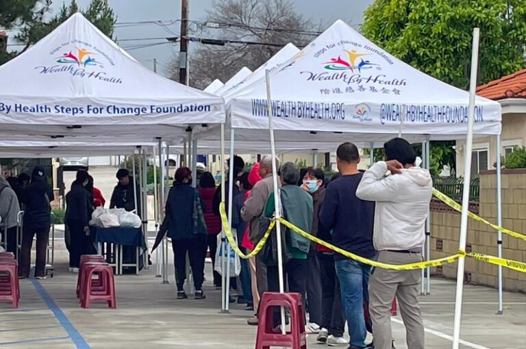 Free food is distributed in a Chinese neighborhood in Los Angeles County, with hundreds of people standing in long lines despite the rain.

